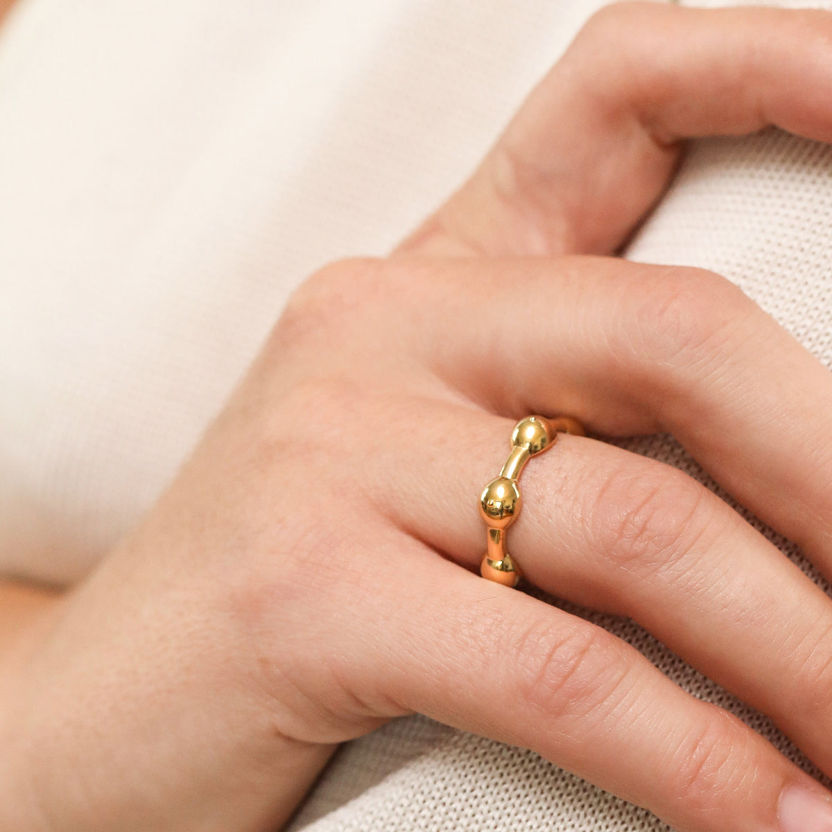 Gold Seeded Eternity Ring on model&#39;s hand close up